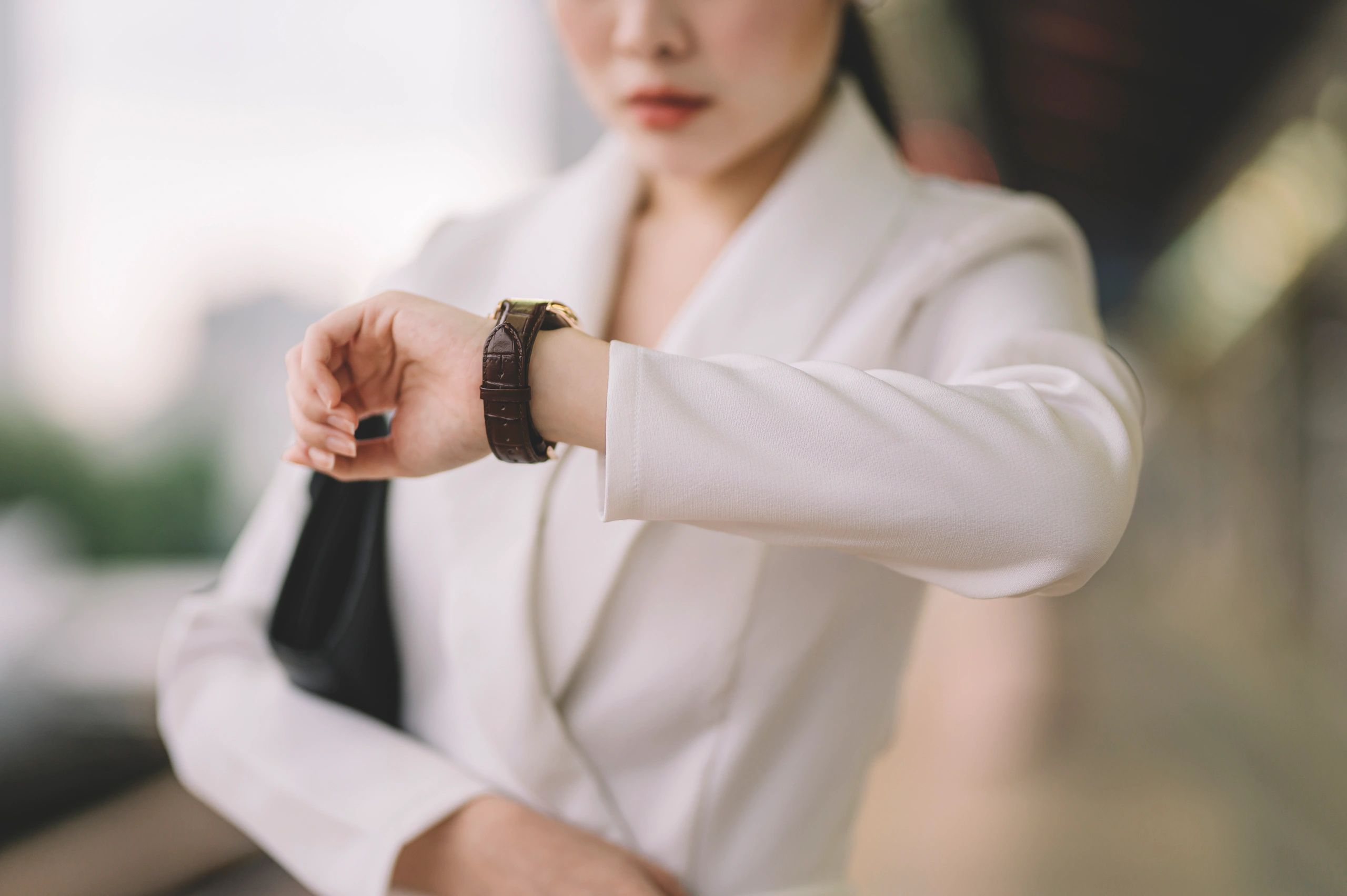 Woman checking time on a stylish wristwatch