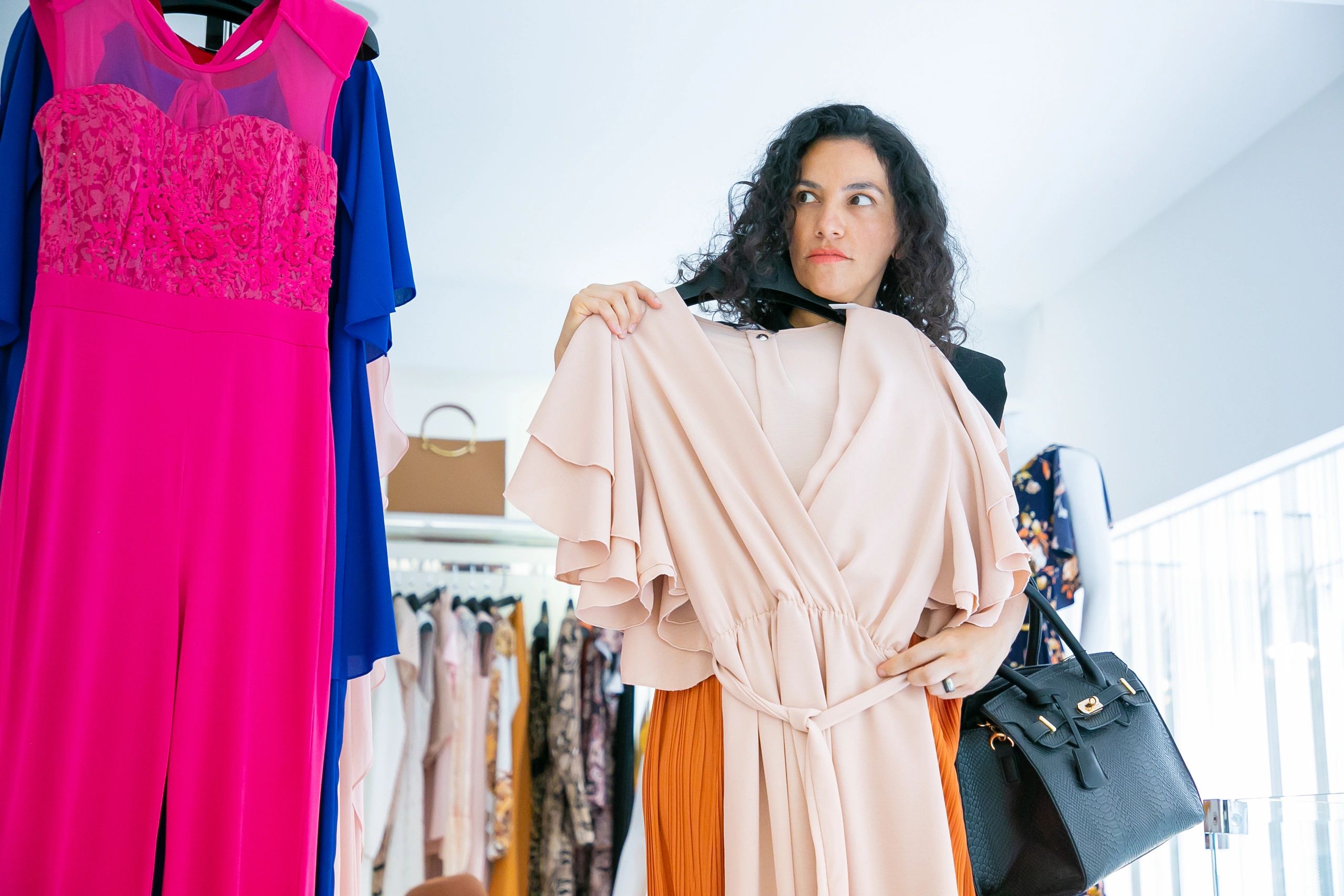 Woman choosing clothing in fashion store