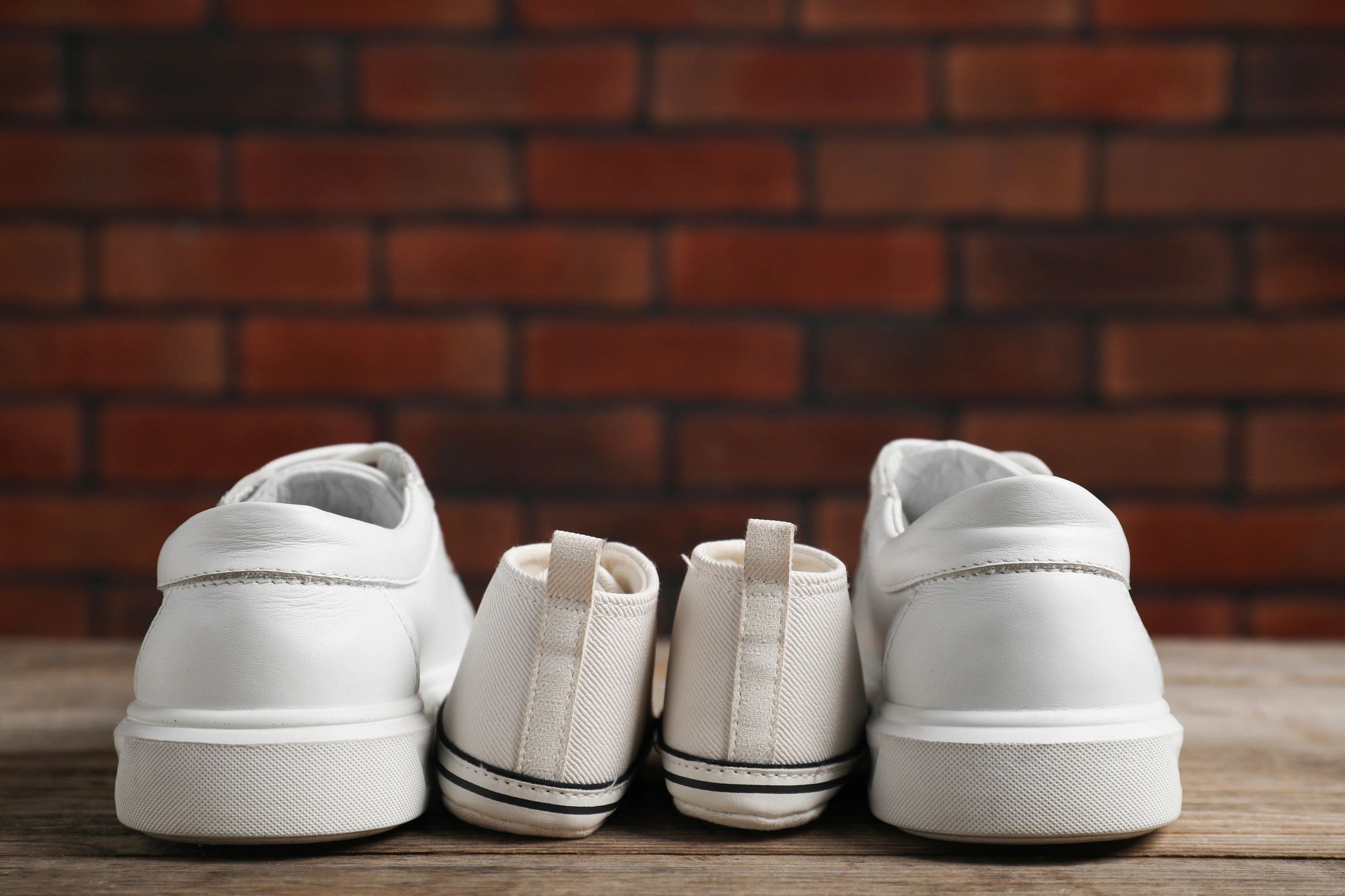 Sneakers and footwear arranged on a wooden surface