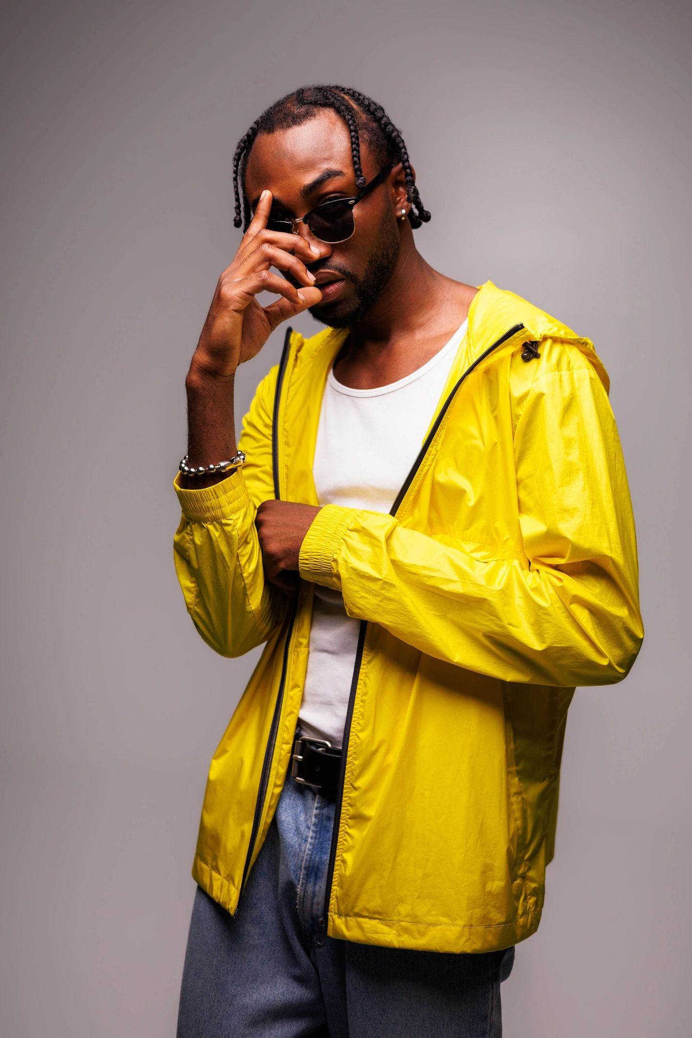Stylish man in sunglasses and jacket in studio