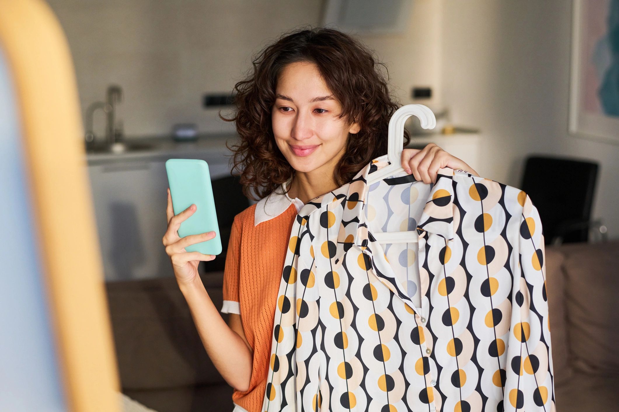 Woman reviewing fashion product on smartphone
